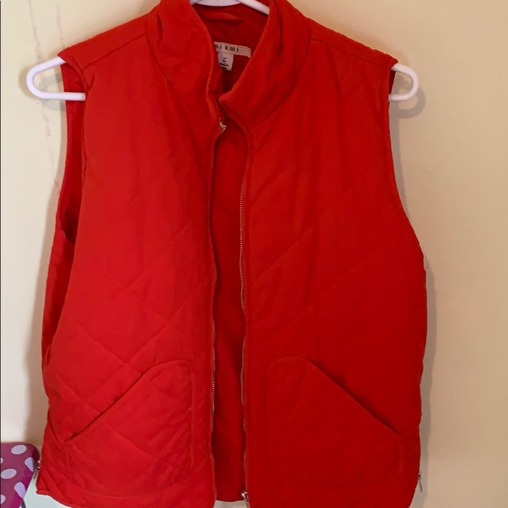 Orange vest with gold zippers.